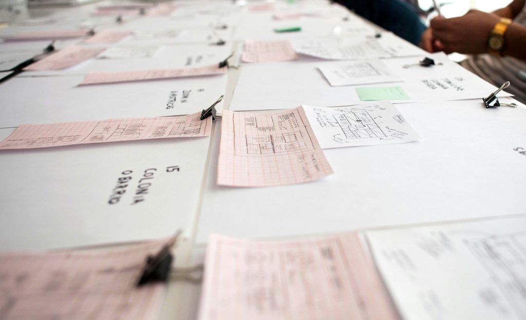 Image of paper checks on the table, showing the struggles and limitations of paper check.